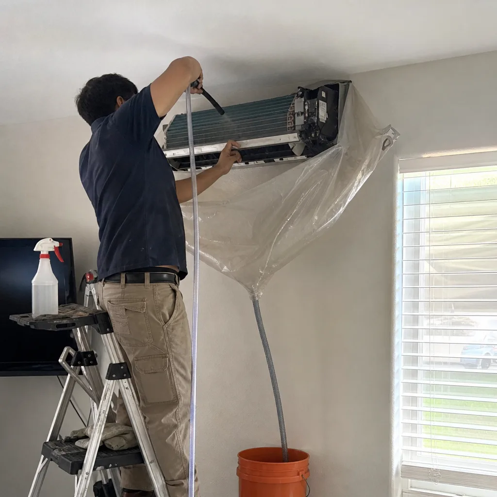 HVAC technician performing professional air conditioner coil cleaning service